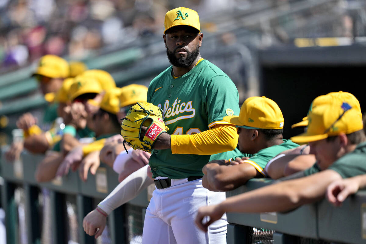 Athletics pitcher Luis Severino waits to take the field prior to a spring training baseball gam ...