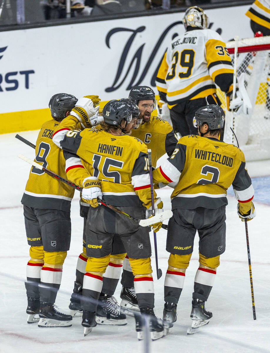 Golden Knights players celebrate a goal against Pittsburgh Penguins goaltender Alex Nedeljkovic ...