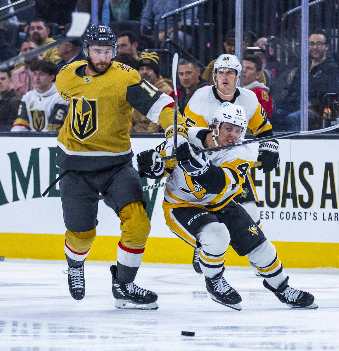 Golden Knights center Nicolas Roy (10) and Pittsburgh Penguins center Blake Lizotte (46) battle ...