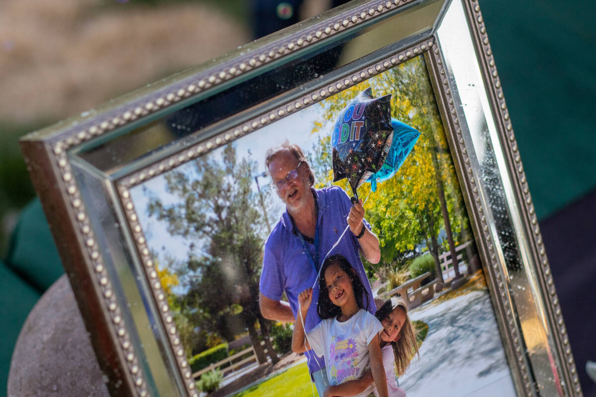 A photo of James “Jimmy” McCoy with his two daughters, Lili and Yoyo Wang, sits on a table ...