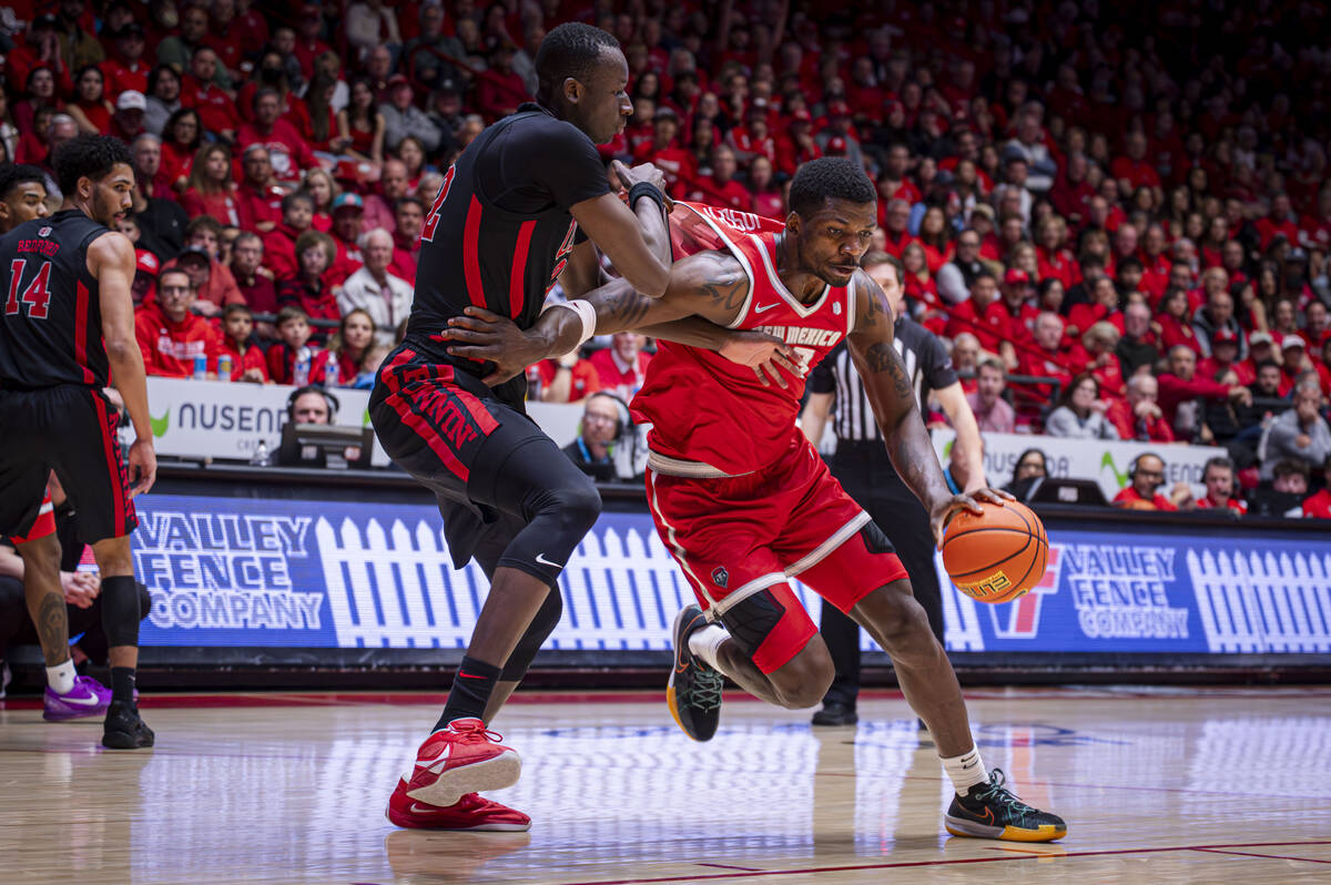UNLV center Pape N’Diaye, left, guards New Mexico center Nelly Junior Joseph at The Pit in Al ...
