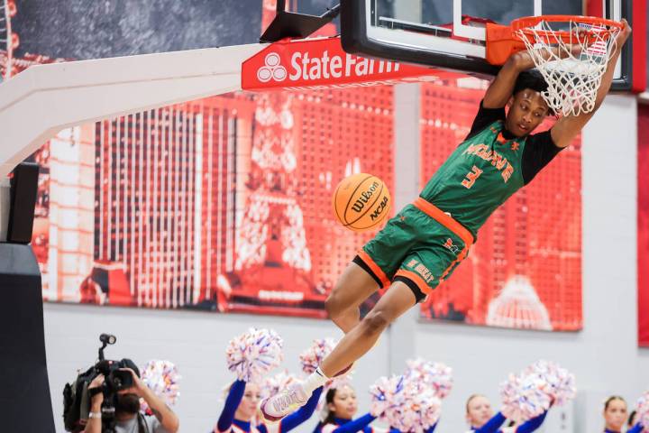 Mojave guard C.J. Shaw dunks the ball during the Class 5A boys basketball state championship ga ...