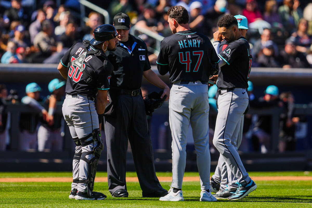 An umpire discusses with Arizona Diamondbacks players during a Big League Weekend baseball game ...