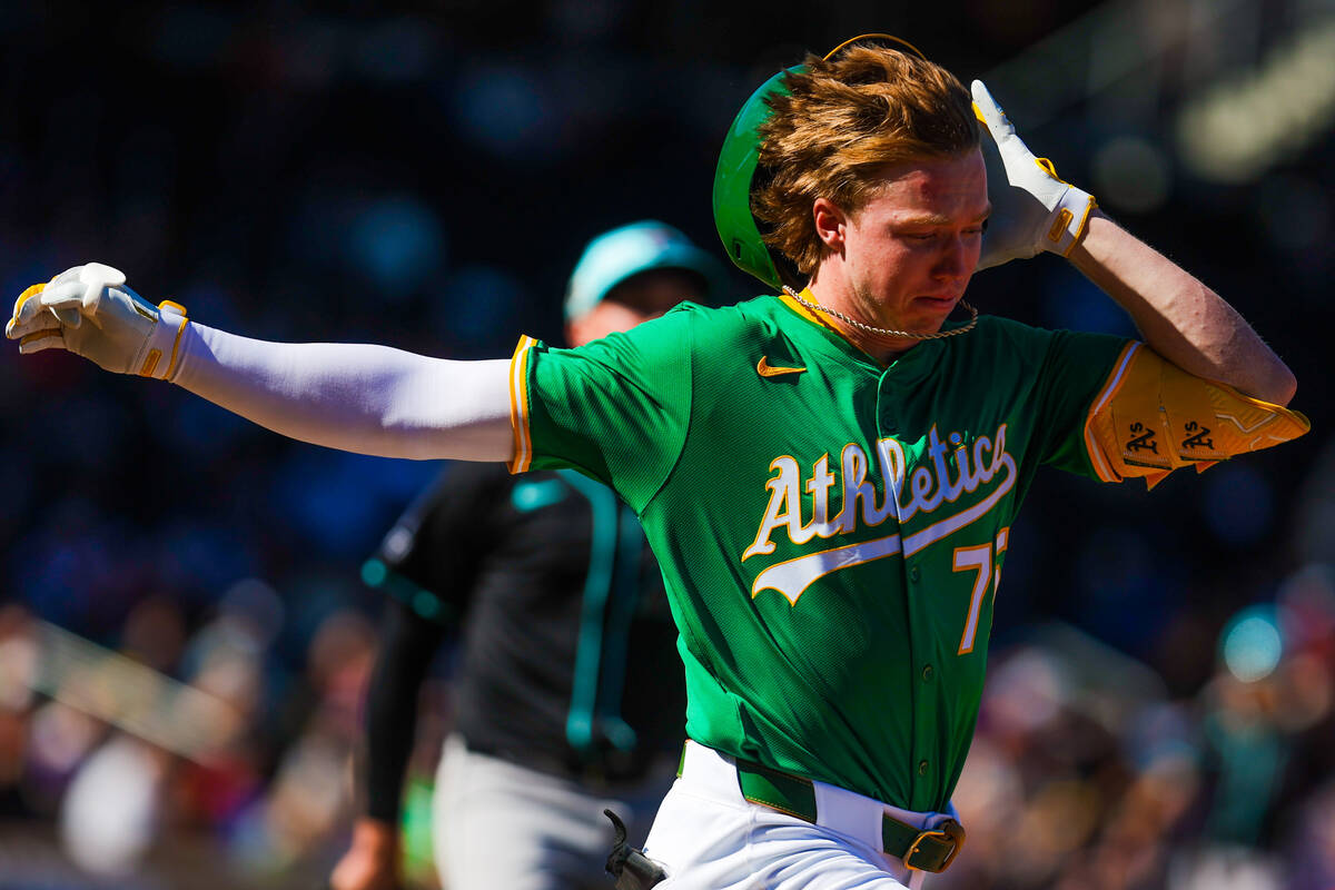 Athletics outfielder Henry Bolte loses his helmet during a run to first base at a Big League We ...