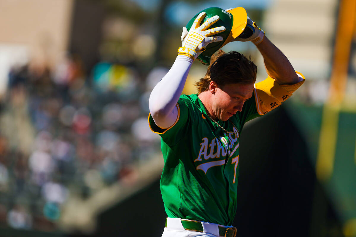Athletics outfielder Henry Bolte loses his helmet during a run to first base at a Big League We ...