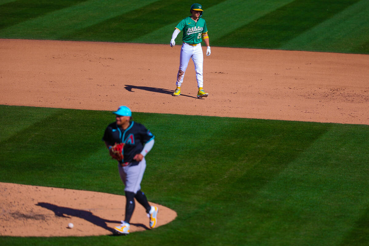 Athletics catcher Shea Langeliers (23) walks back to the dugout after the end of an inning duri ...