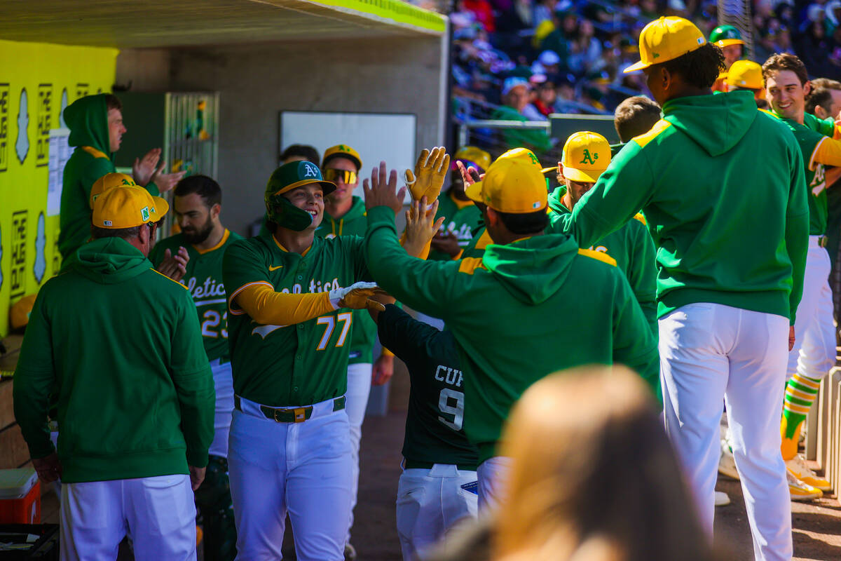 Athletics infielder Nick Kurtz (77) is greeted with high fives in the dugout after a home run i ...