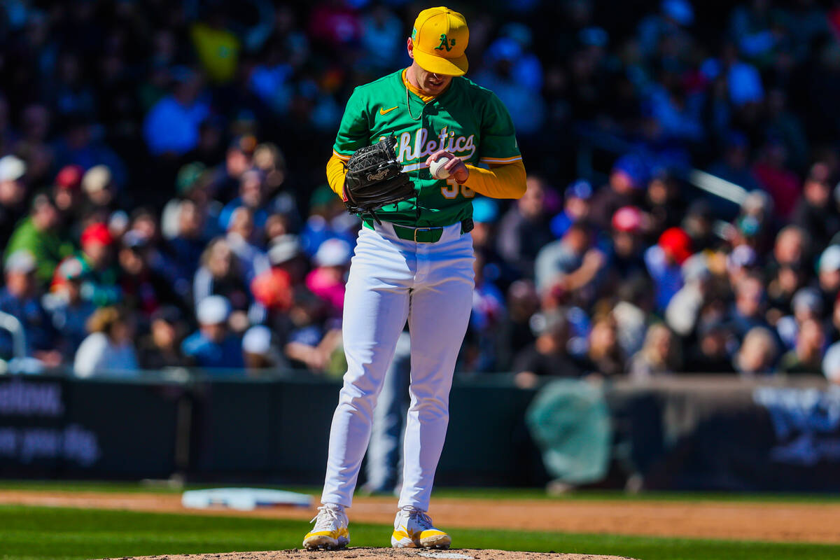 Athletics pitcher JP Sears inspects a ball during a Big League Weekend baseball game between th ...