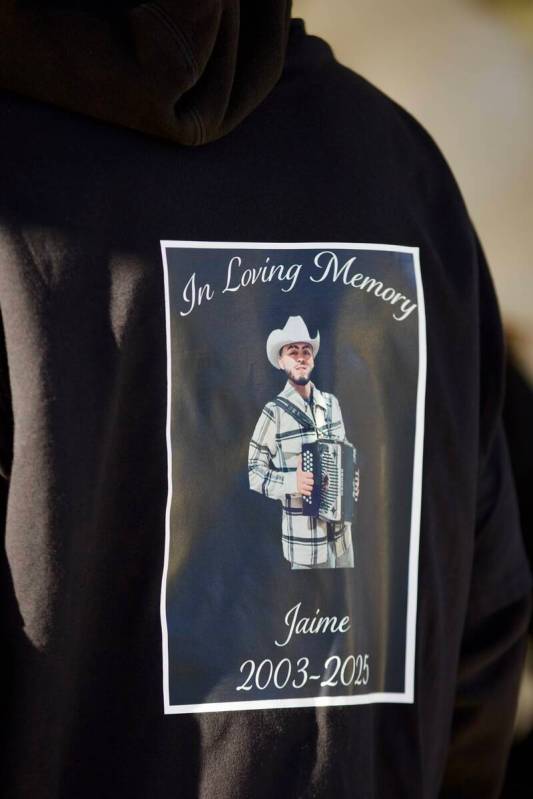An attendee wears a shirt with a picture of Jaime Zamora on it during a candlelight vigil and b ...