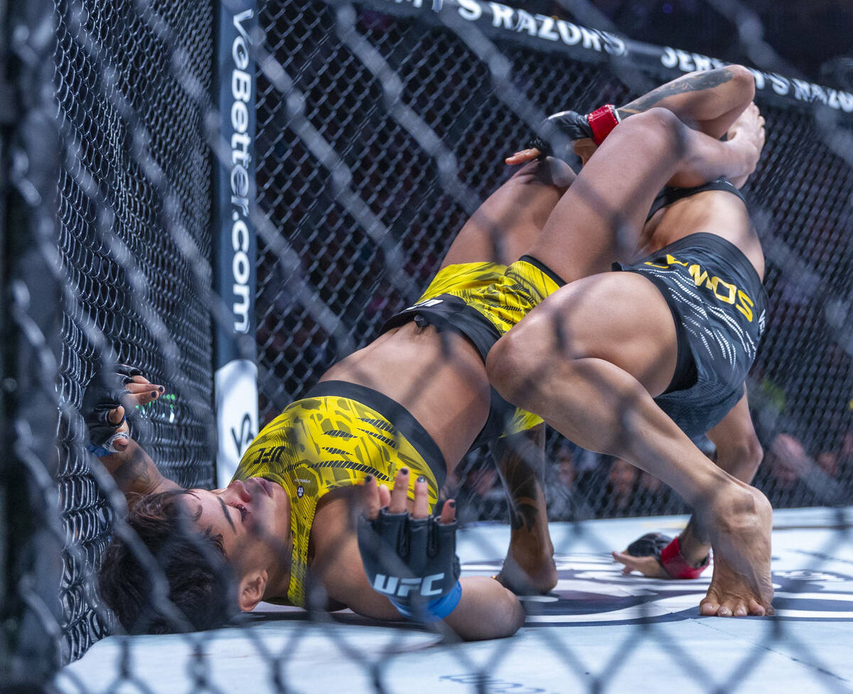 Amanda Lemos is held down by Iasmin Lucindo during their women’s strawweight fight at UF ...