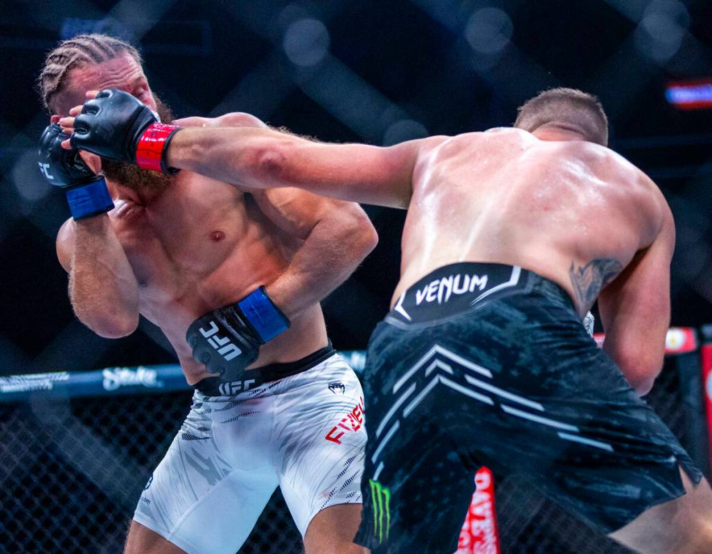 Rafael Fiziev takes a punch from Justin Gaethje during their lightweight fight at UFC 313 in th ...