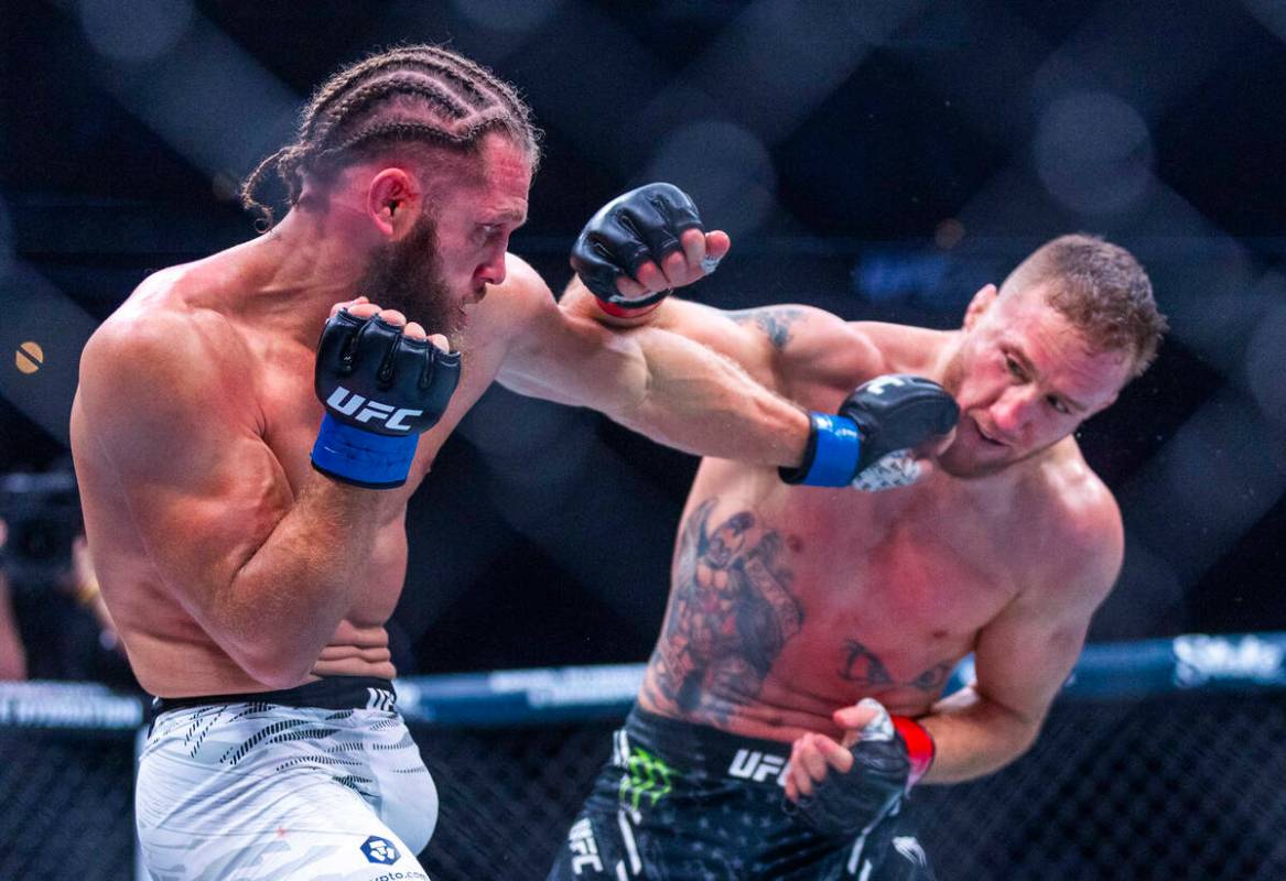 Rafael Fiziev and Justin Gaethje trade punches during their lightweight fight at UFC 313 in the ...