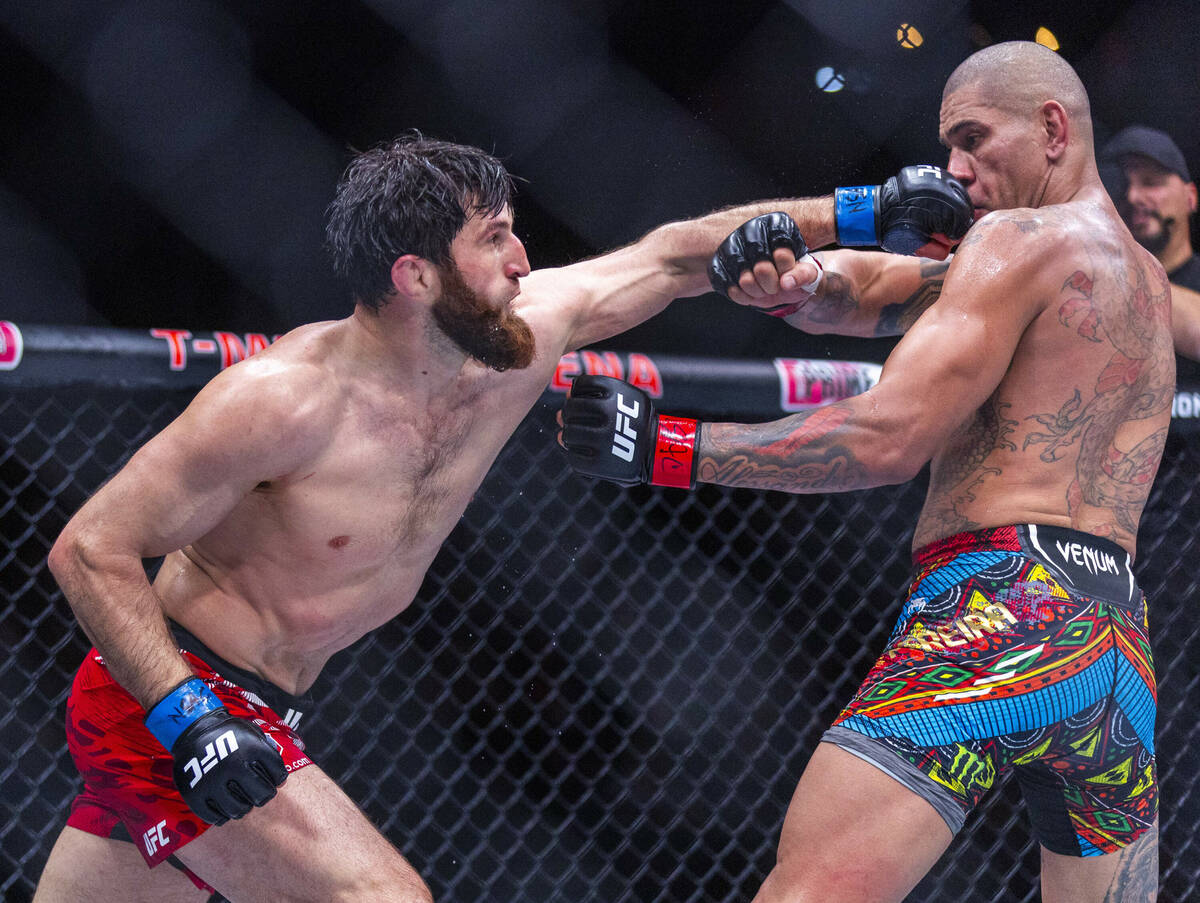 Magomed Ankalaev punches Alex Pereira in the face during their light heavyweight fight at UFC 3 ...