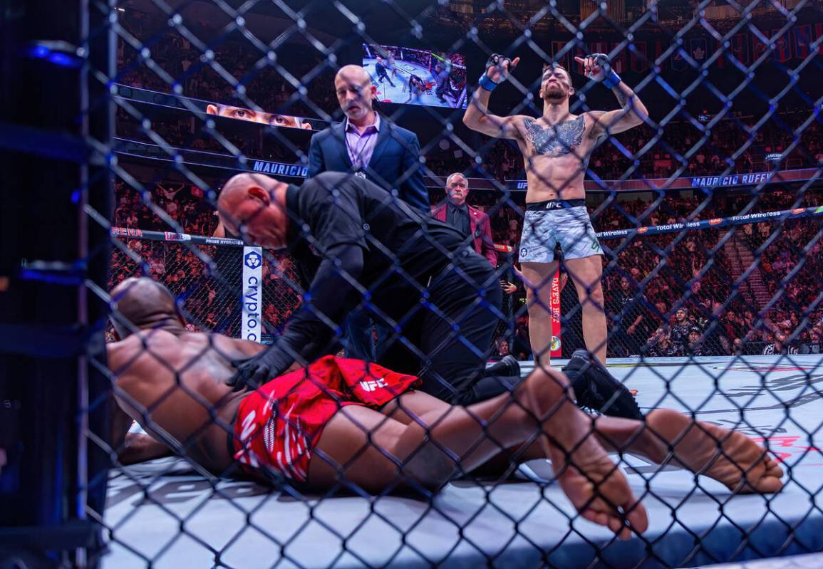 King Green is knocked out as Mauricio Ruffy celebrates his win during their lightweight fight i ...
