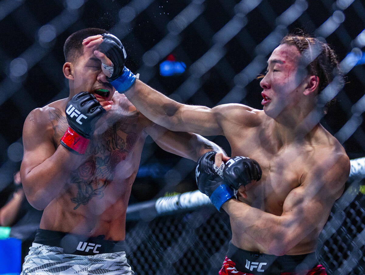 Joshua Van takes a glove to the face from Rei Tsuruya during their flyweight fight in UFC 313 a ...