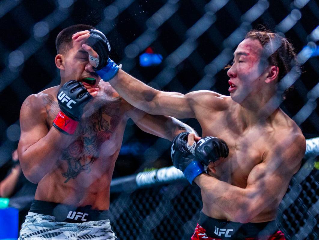 Joshua Van takes a glove to the face from Rei Tsuruya during their flyweight fight in UFC 313 a ...