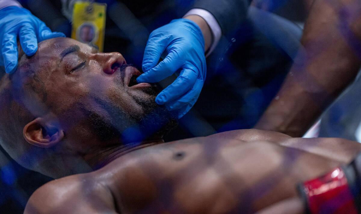 King Green has his mouthpiece removed after being knocked out by Mauricio Ruffy during their li ...