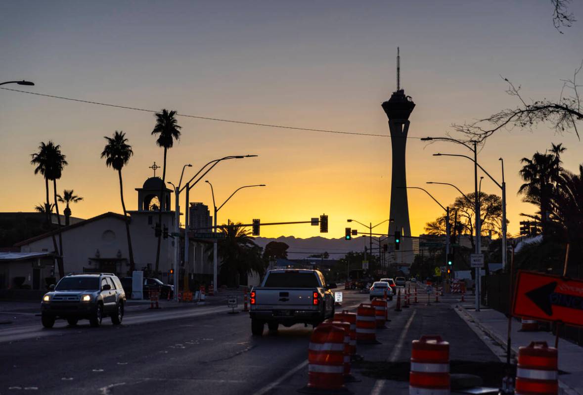 Vehicles pass by along St. Louis Avenue as the sun sets on Sunday, March 9, 2025, in Las Vegas. ...