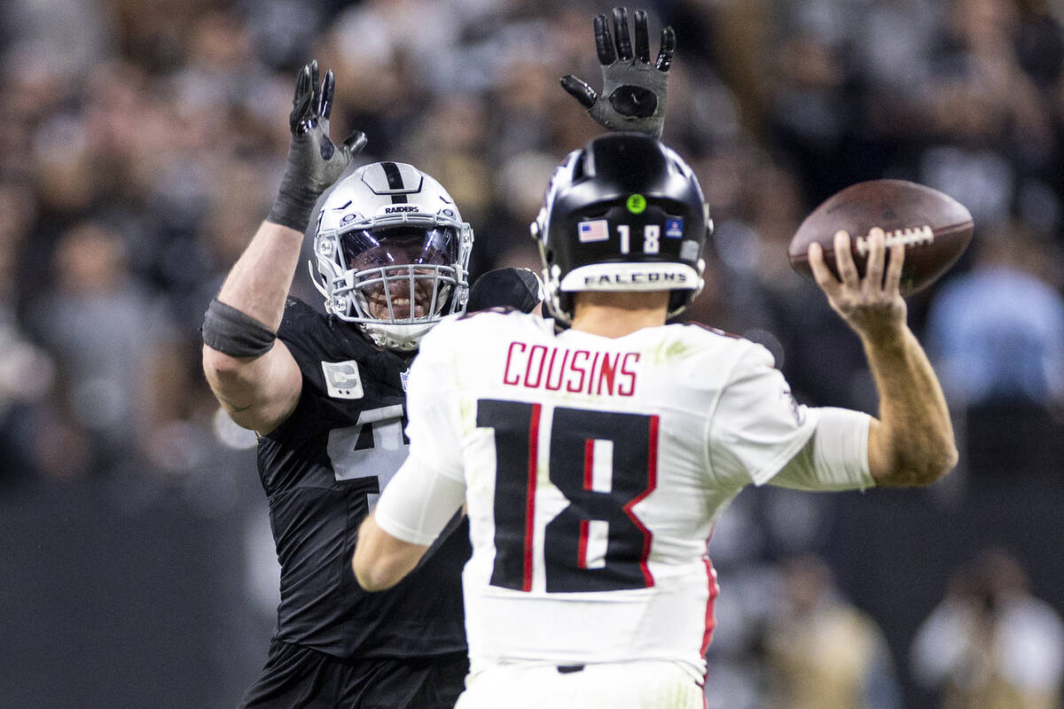 Raiders linebacker Robert Spillane, left, rushes Atlanta Falcons quarterback Kirk Cousins (18), ...