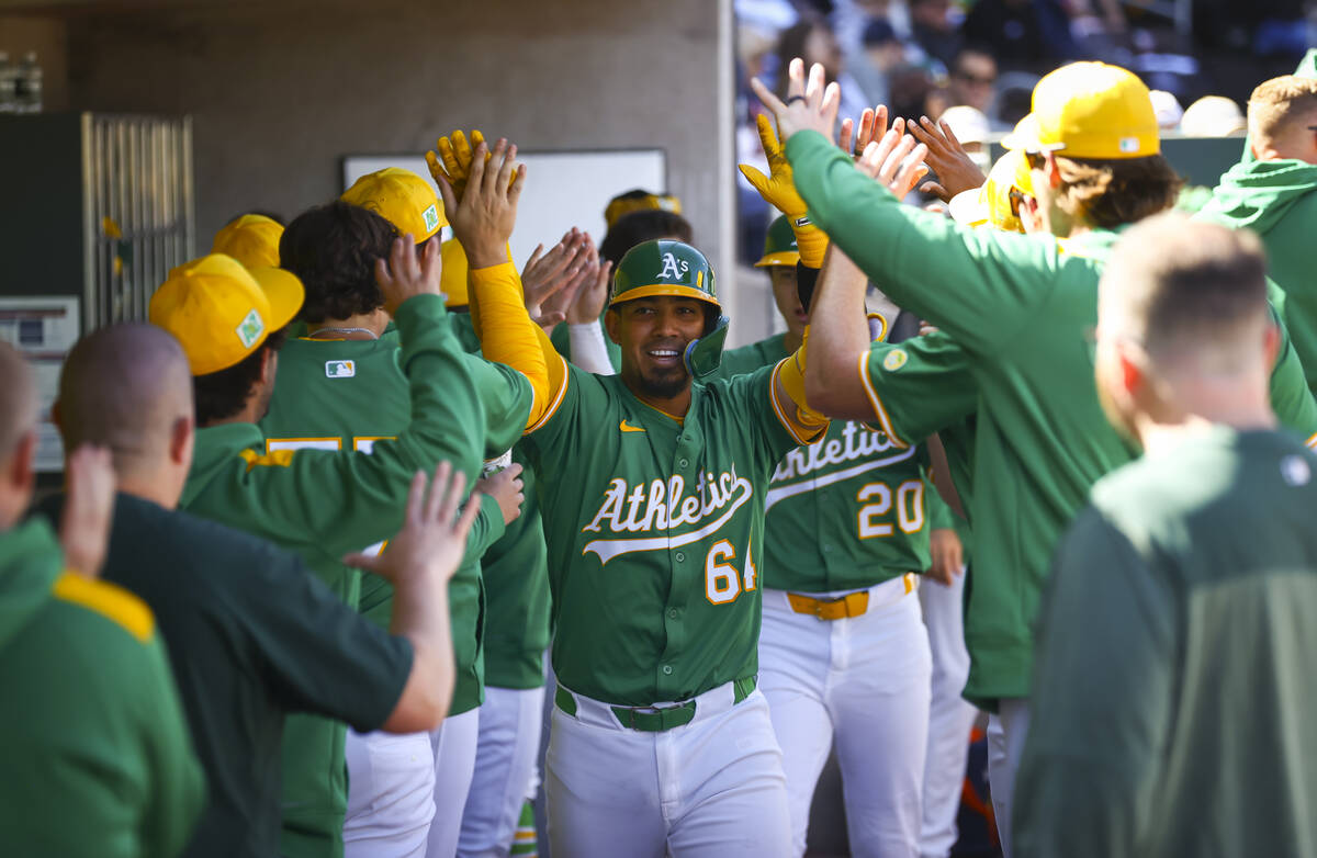 Athletics catcher Jhonny Pereda (64) celebrates his home run with teammates during a Big League ...