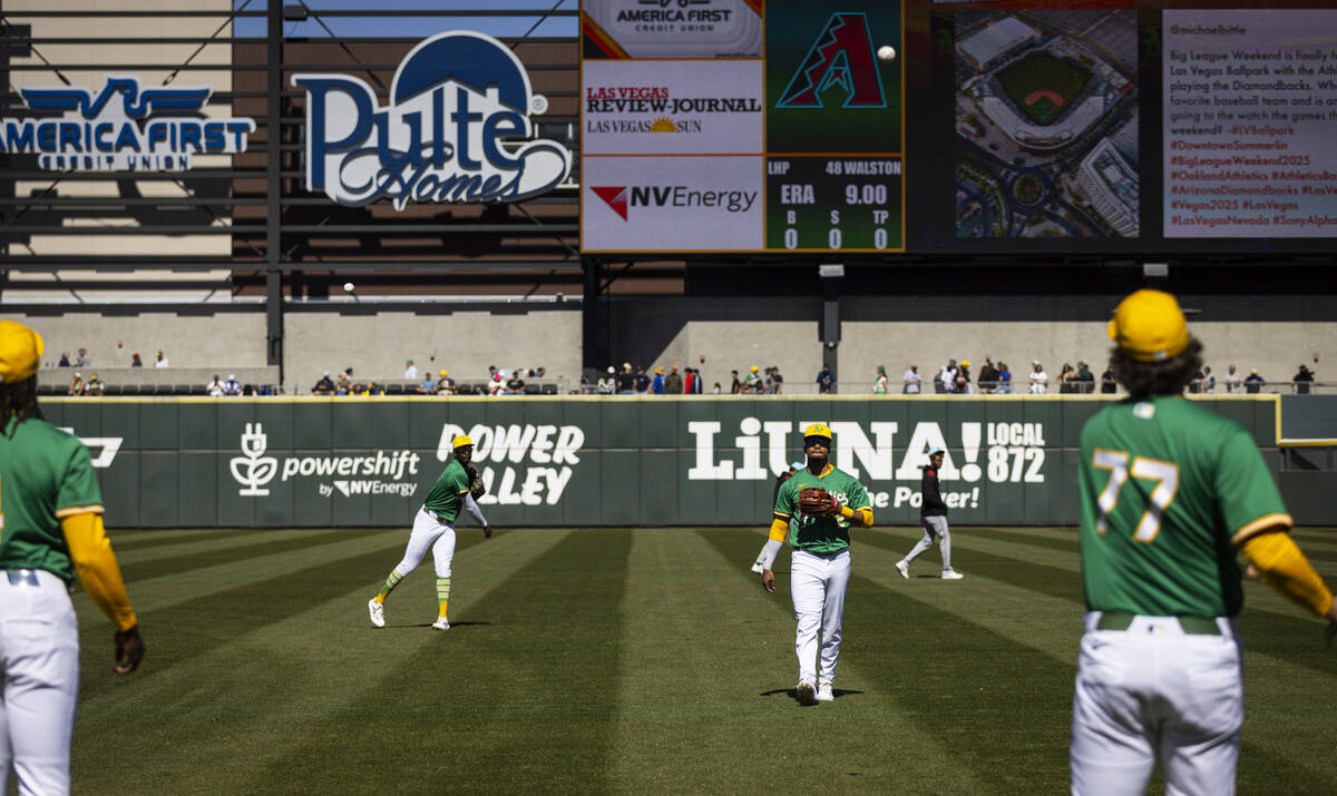 Athletics players warm up before playing the Arizona Diamondbacks during a Big League Weekend b ...