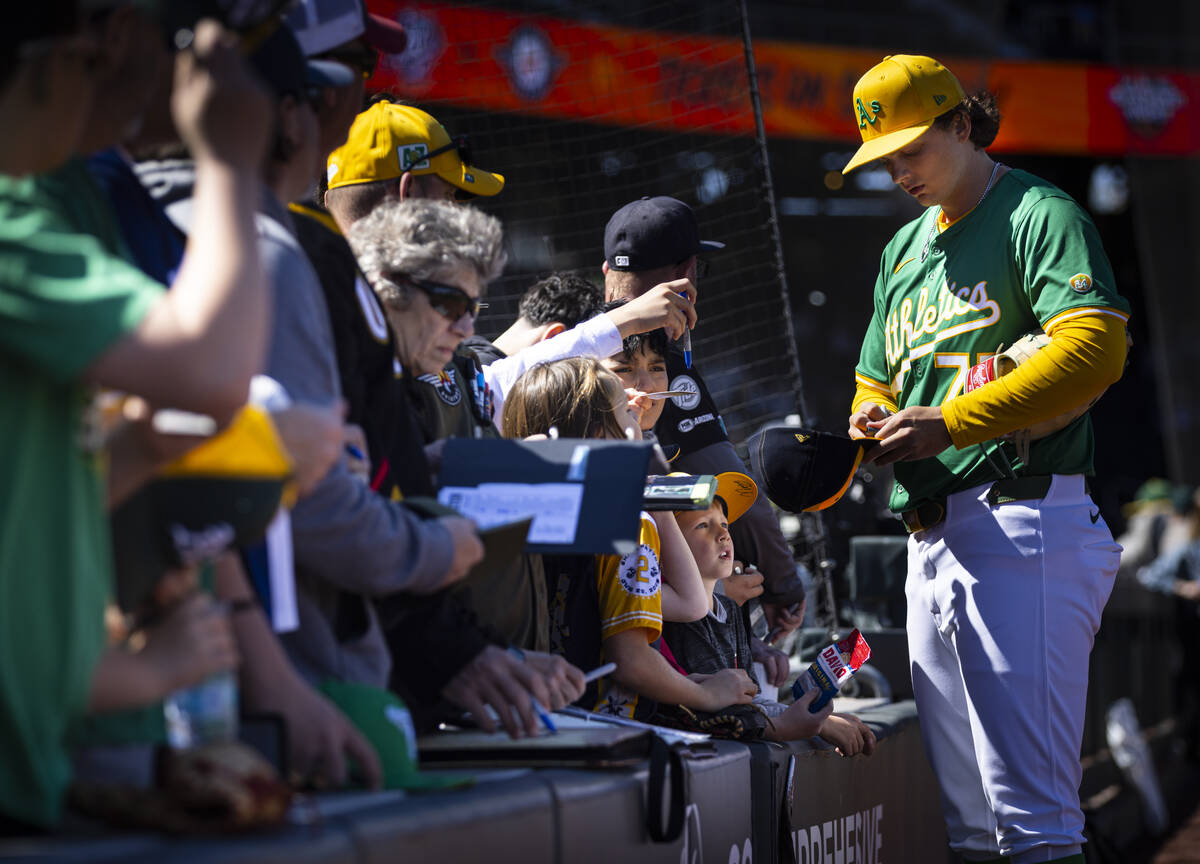 Athletics’ Nick Kurtz (77) signs autographs for fans before a Big League Weekend basebal ...