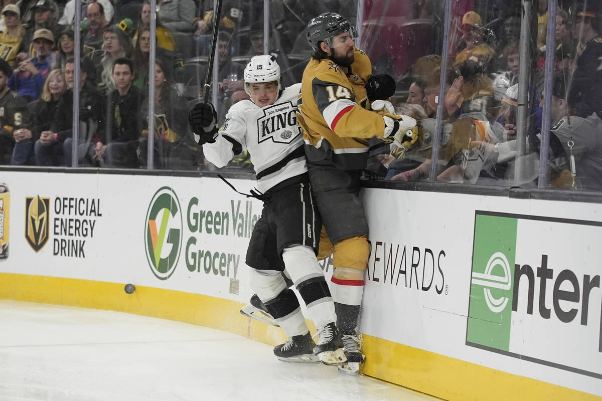Los Angeles Kings center Alex Turcotte (15) checks Vegas Golden Knights defenseman Nicolas Hagu ...