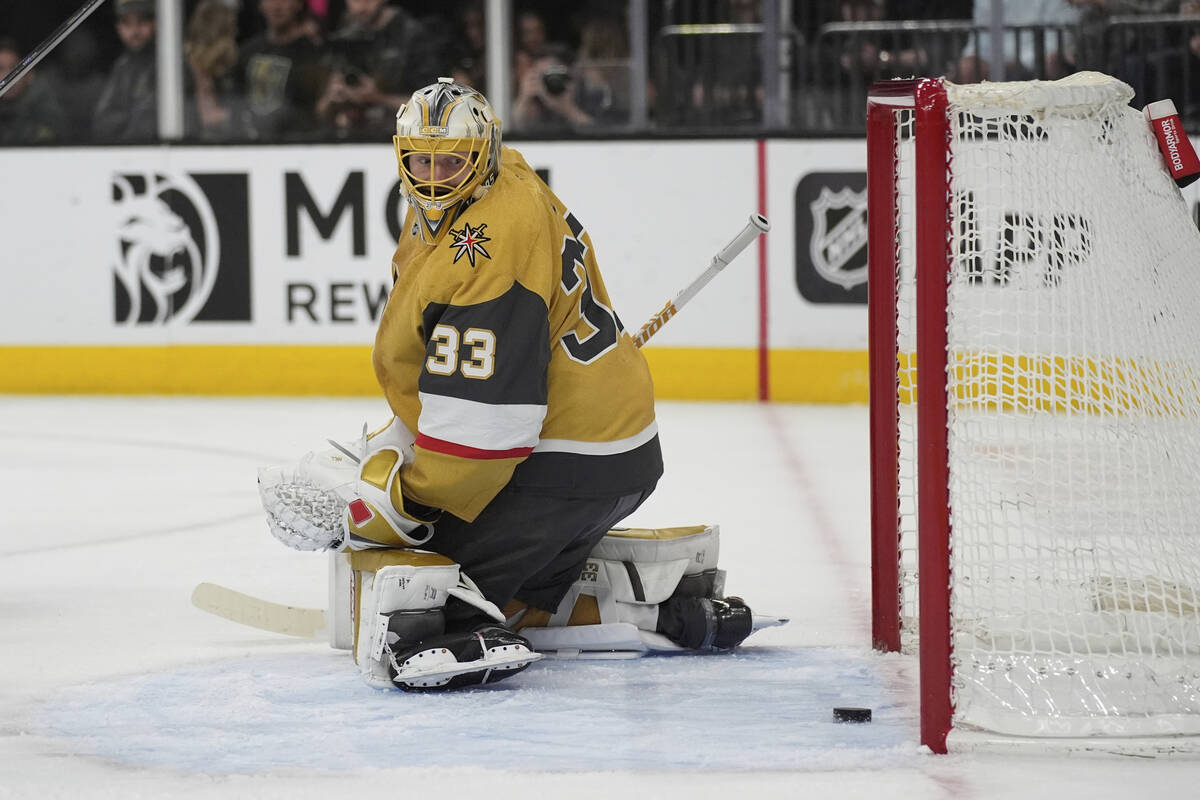 Vegas Golden Knights goaltender Adin Hill (33) looks at the puck after he was scored on by Los ...
