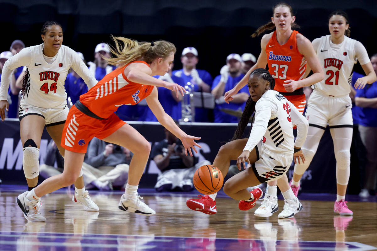 UNLV Lady Rebels guard Amarachi Kimpson (33) battles for the ball against Boise State Broncos g ...