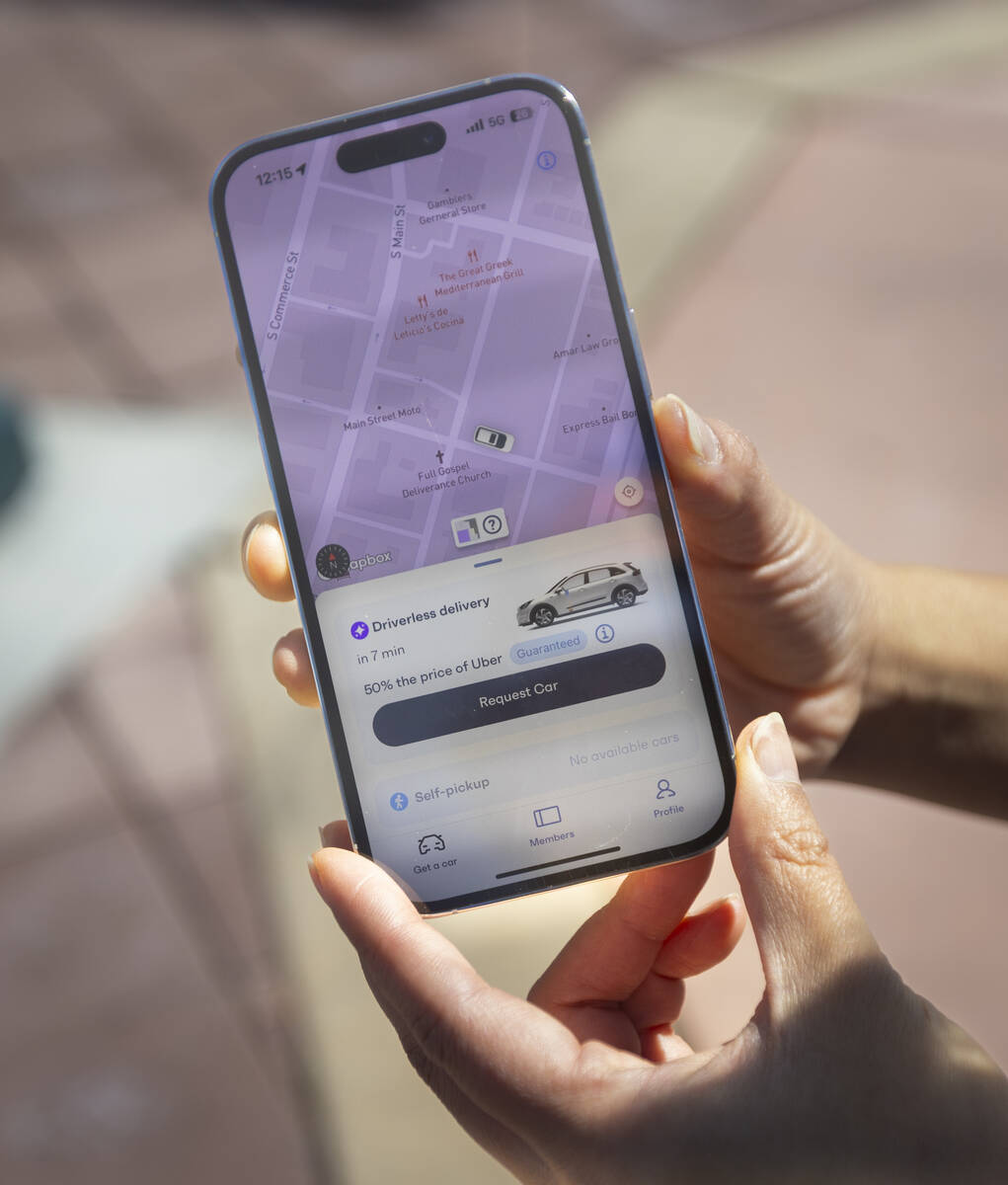 Ivy Chiou of Vay orders a vehicle from the company’s app on Monday, March 10, 2025, in downto ...
