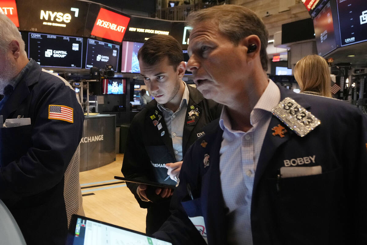 Traders work on the floor of the New York Stock Exchange, Tuesday, March 11, 2025. (AP Photo/Ri ...