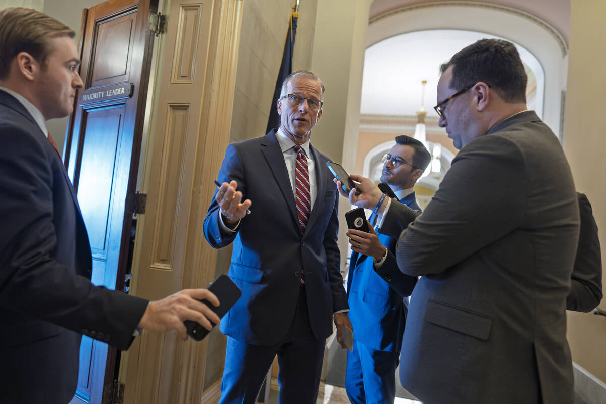 Reporters pose questions to Senate Majority Leader John Thune, R-S.D., as Republicans work to p ...