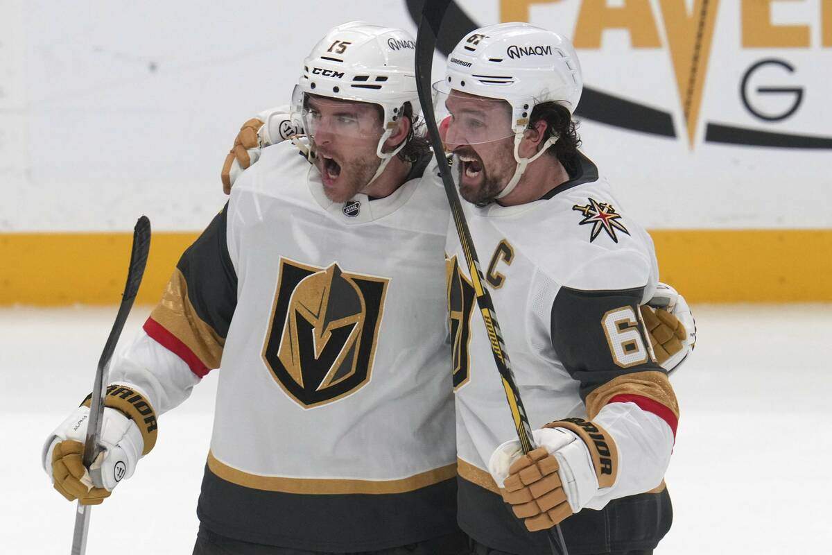 Vegas Golden Knights' Noah Hanifin (15) celebrates with Mark Stone after scoring during the thi ...