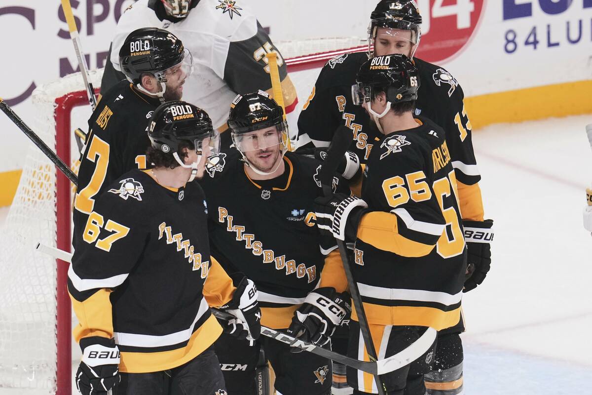 Pittsburgh Penguins' Sidney Crosby (87) celebrates with teammates after scoring during the firs ...