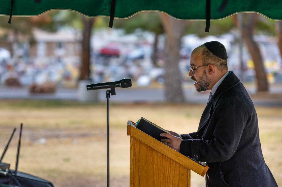 DJ Sinai, Music Director of Temple Beth Shalom, reads Psalm 23 as others recite along during a ...