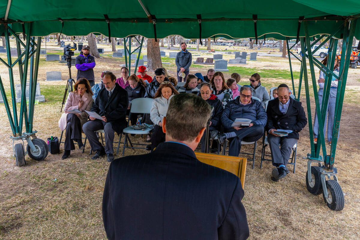 Dr. ken Moskowitz, President and CEO of JFSA, joins others in reading the names of 54 indigent ...