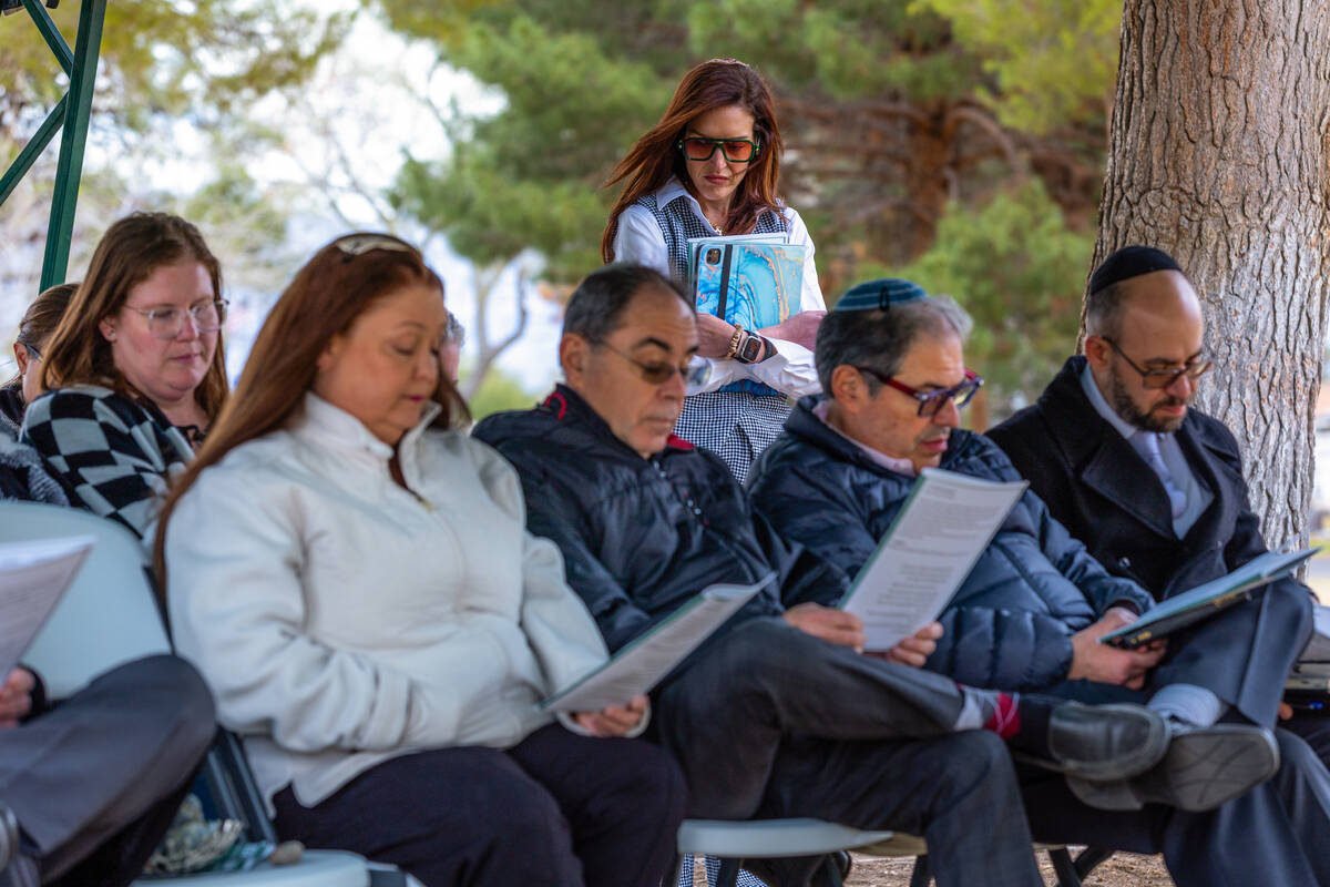 Cantor Jessica Hutchings, Clergy of Congregation Ner Tamid, stands with others during a service ...