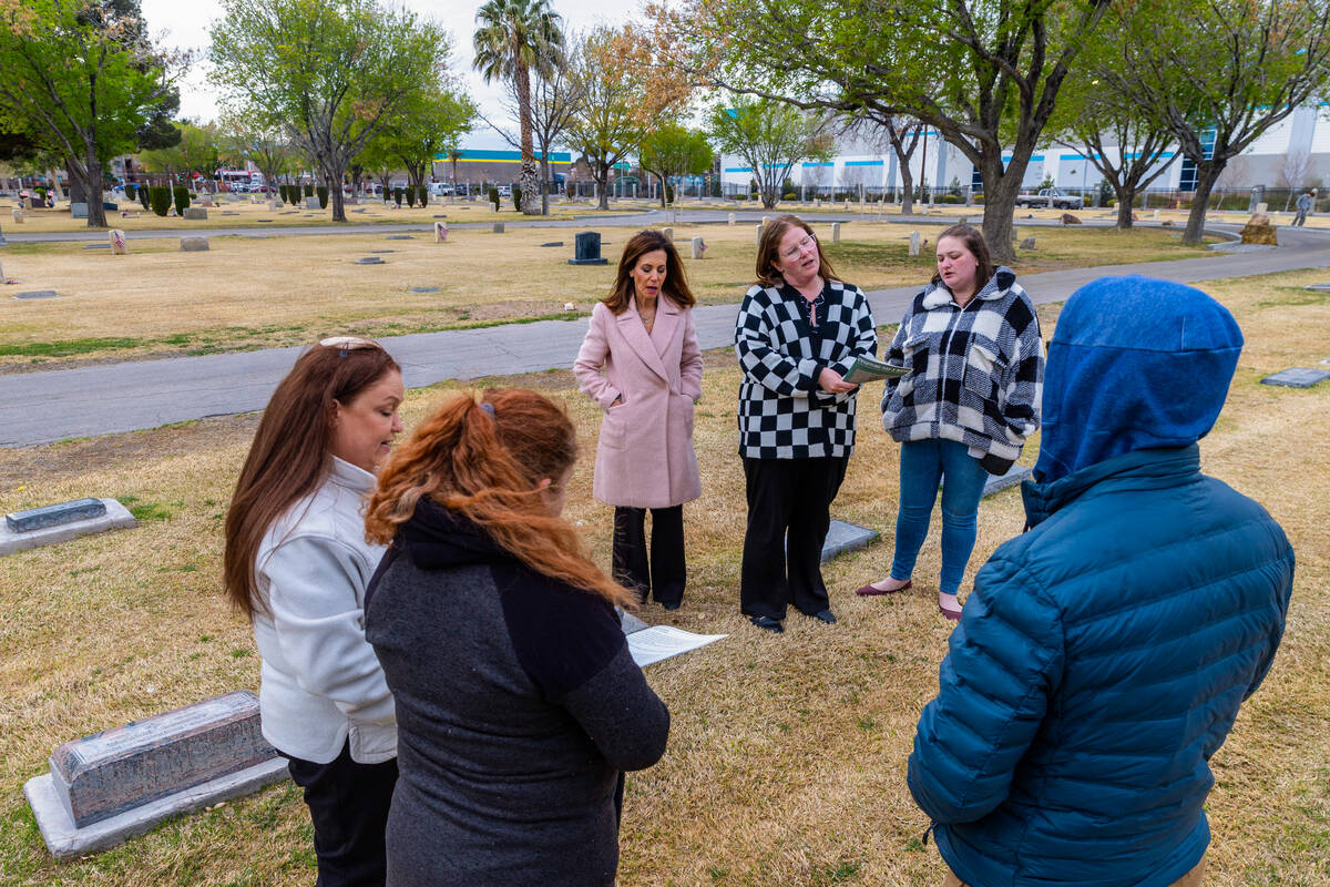 Attendees recite The Kaddish following a service as the local Jewish community marks the graves ...