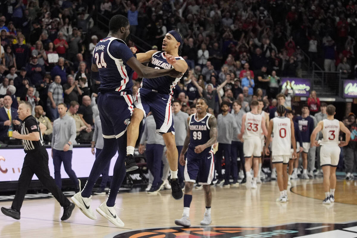 Gonzaga center Ismaila Diagne (24) and Gonzaga guard Ryan Nembhard (0) celebrate after defeatin ...