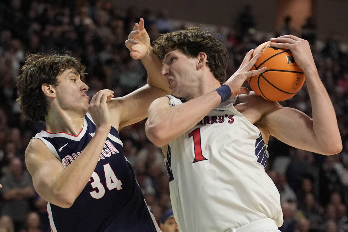 Saint Mary's center Harry Wessels (1) and Gonzaga forward Braden Huff (34) battle for a rebound ...