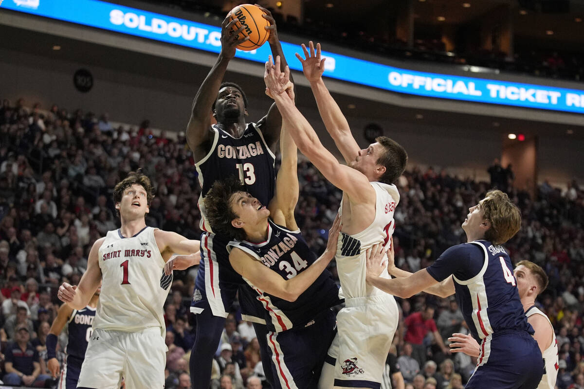 Gonzaga forward Graham Ike (13), Gonzaga forward Braden Huff (34) and Saint Mary's center Mitch ...