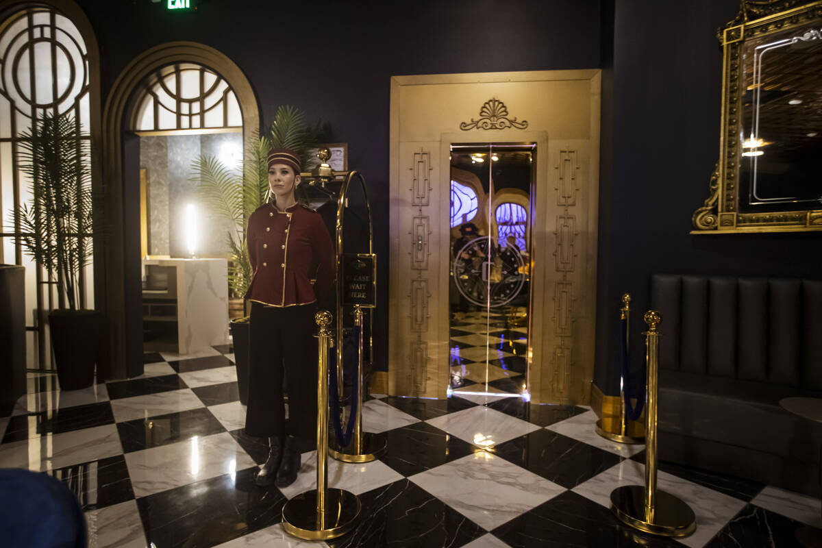 Byron Smith, a performer with the John Wick Experience, waits to guide guests to the elevator a ...