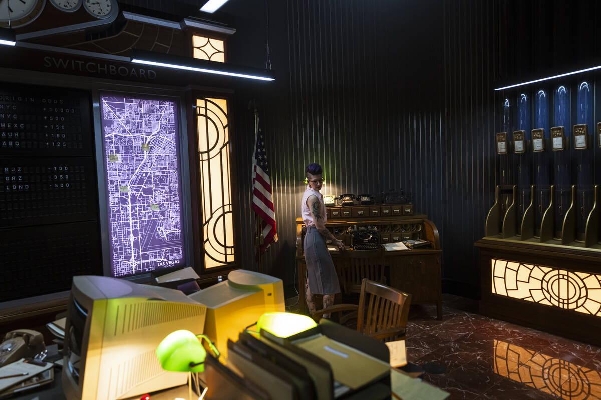 Tii Riga, a performer with the John Wick Experience, works in the switchboard room at the immer ...