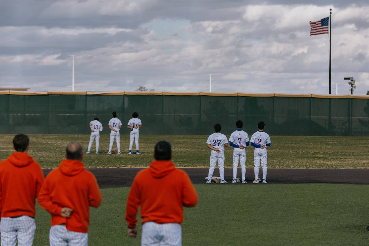 Members of Bishop Gorman’s team line up on the field for the playing of the National Ant ...
