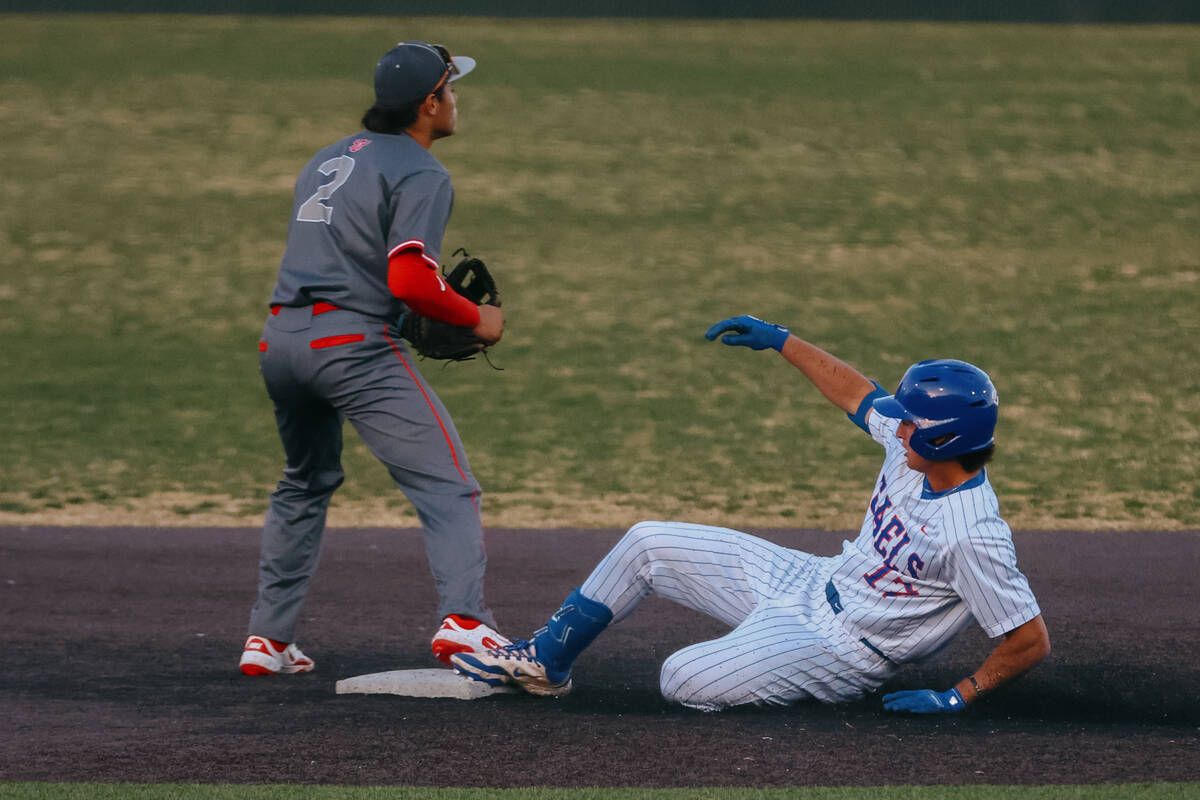 Bishop Gorman runner Nolan Eberwein (17) slides into second base as Arbor View second baseman J ...