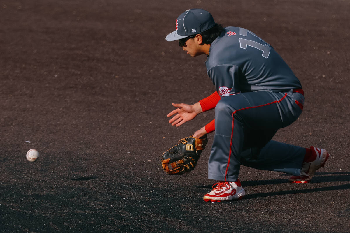 Arbor View first baseman Michael Reed (17) picks up a ground ball during a game against Bishop ...