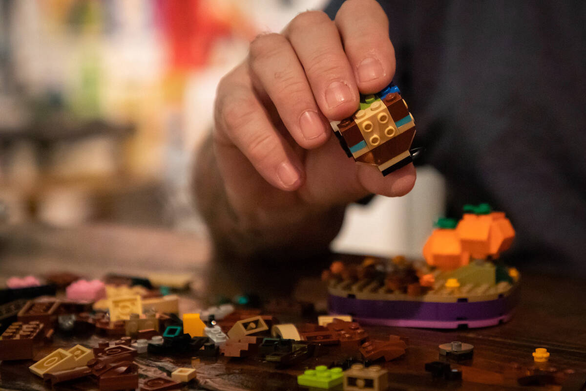 Steve Stephens works on a lego build at the Millenium Fandom Bar “Bricks n’ Booze ...