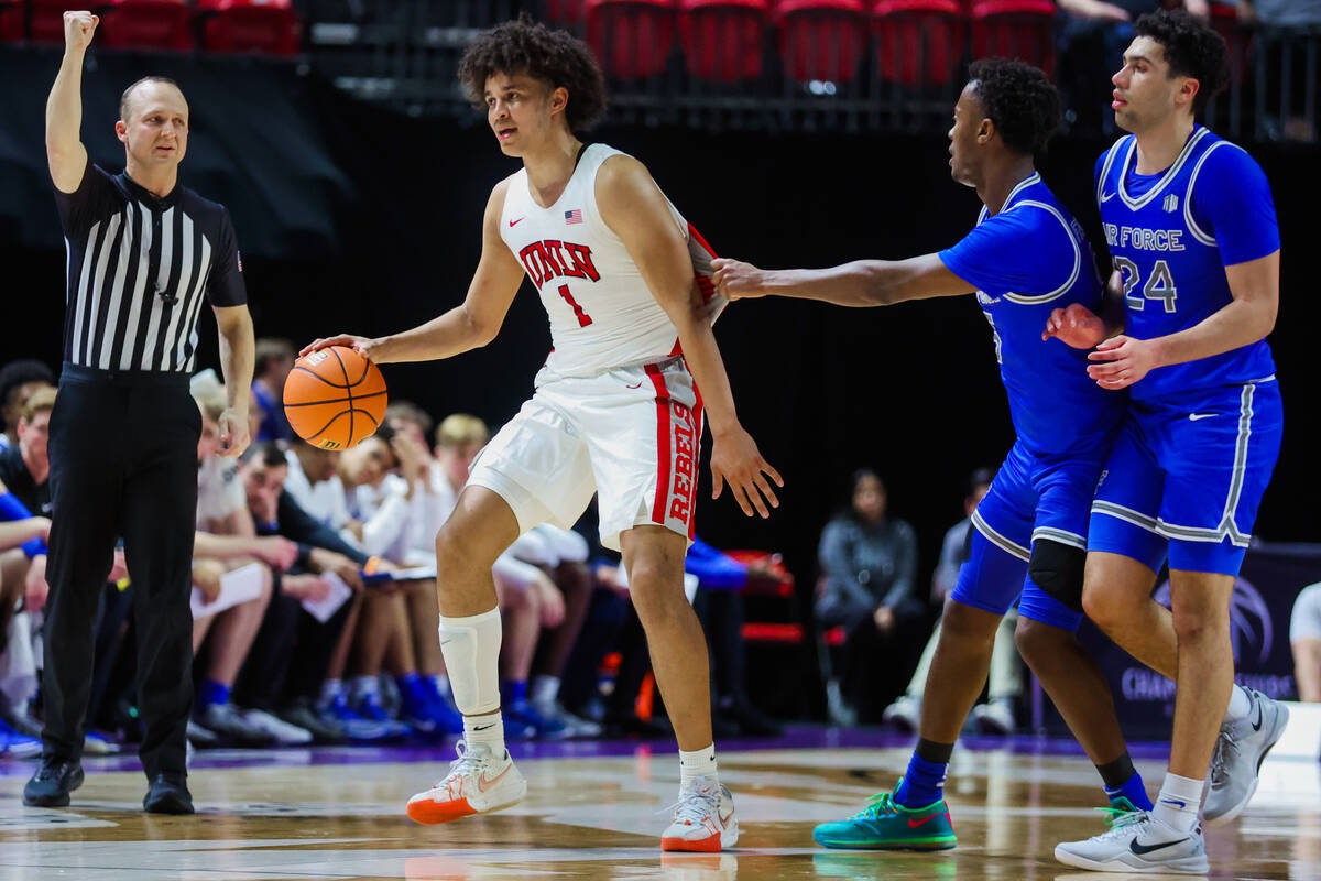 Rebels forward Jalen Hill (1) gets his jersey tugged as a referee calls a foul during a Mountai ...