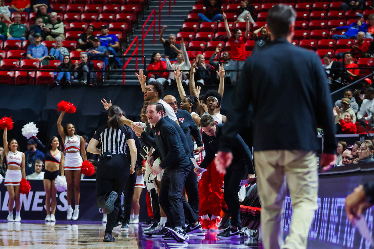 The Rebels cheer from their bench during a Mountain West men’s tournament NCAA basketbal ...