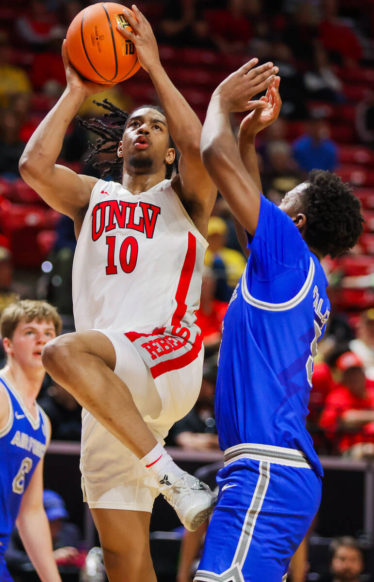 Rebels guard Jaden Henley (10) drives the ball towards the net during a Mountain West men&#x201 ...
